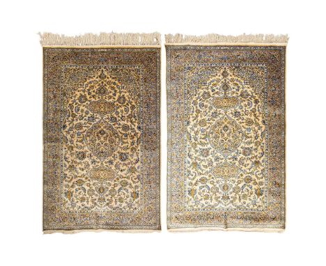 A pair of old silk-on-silk Isfahan rugs, with lacquer red and Persian blue Arabesques around a central mandorla and lanterns 