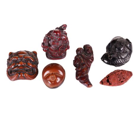 A Japanese carved boxwood netsuke in the form of a Noh theatre Oni mask, the reverse with a further three Noh masks, 3.5 cm w