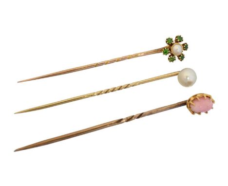 Three stickpins, Three stickpins, to include a demantoid garnet and split pearl stickpin, a conch pearl stickpin and a pearl 
