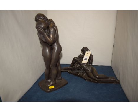 A cast resin bronze effect group modelled as male and female nude figures; and another similar group.