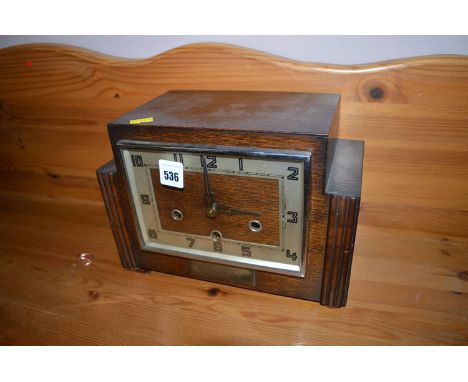 An oak Art Deco mantel clock.