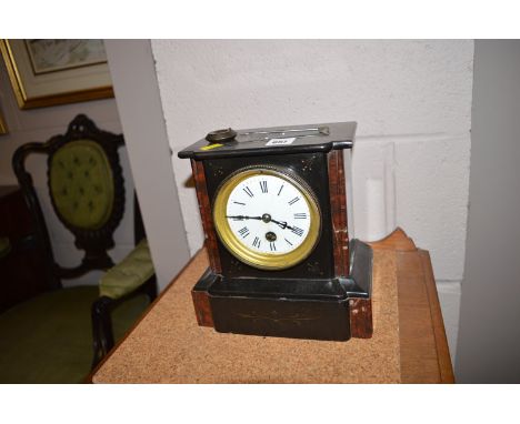 A Victorian mantel clock in black slate and marble case.