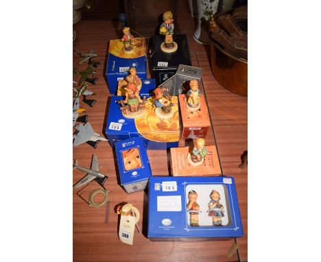 A collection of twelve modern Hummel ceramic figures of children, mostly in original boxes.