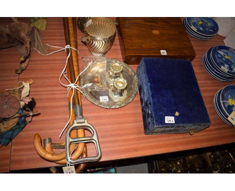 A shooting stick; and three walking canes with white metal mounts; an EPNS egg cruet; plated bottle stand; a set of four meta