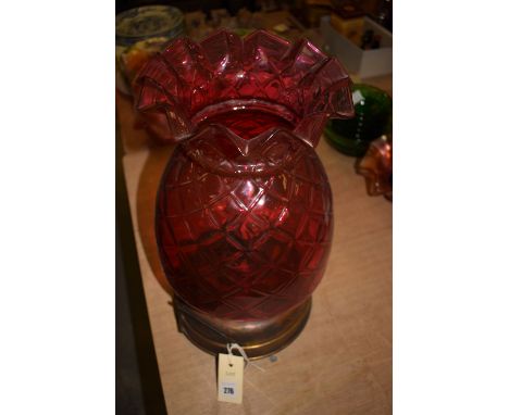 A Victorian table oil lamp, with cranberry glass shade and glass reservoir.