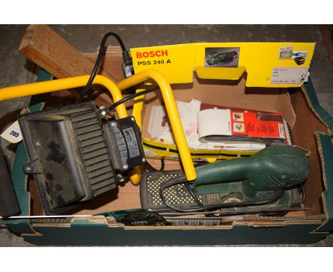 A Bosch electric sander; and an electric spotlight.