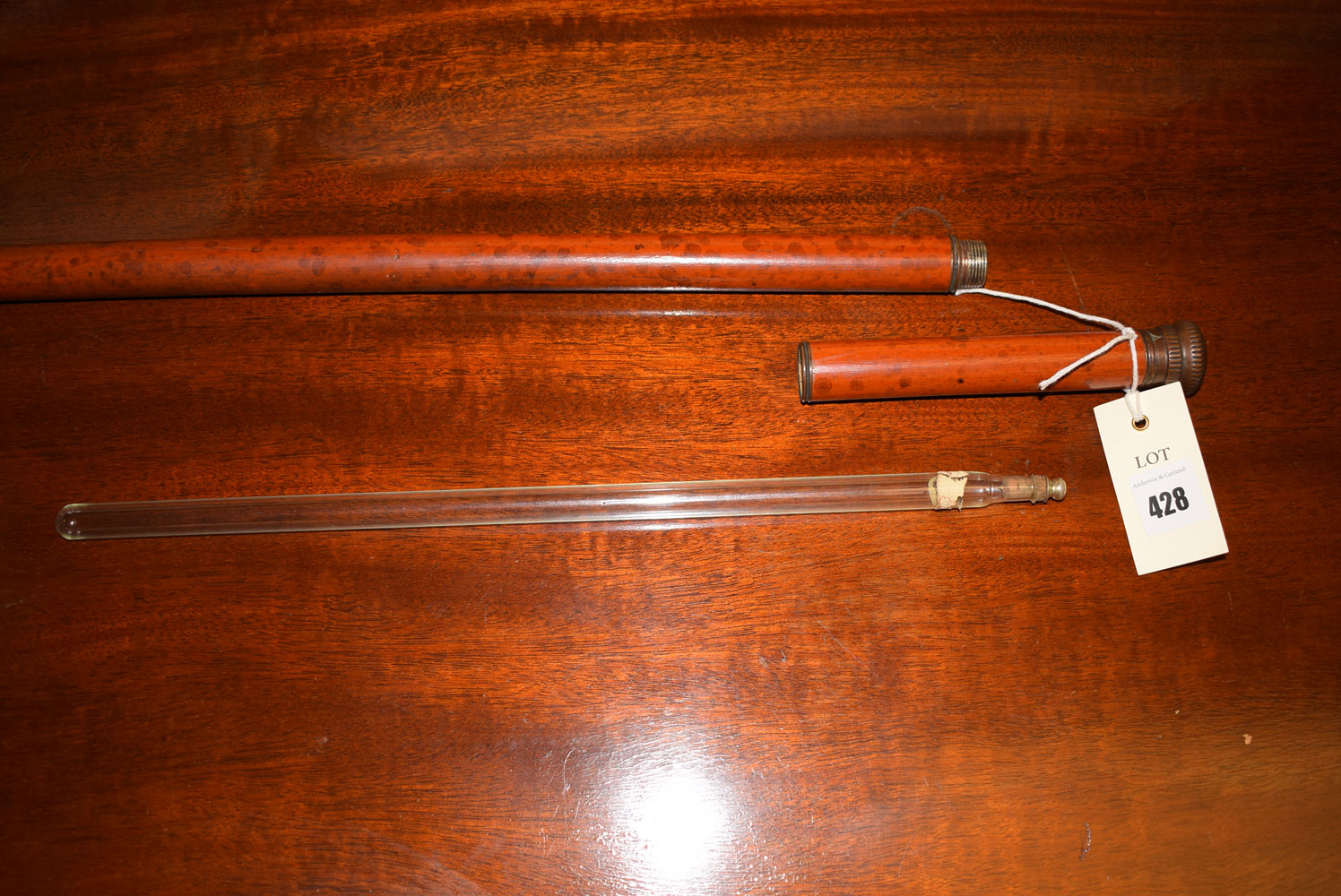 A tipple stick (a walking stick with glass flask inside) and metal pommel.