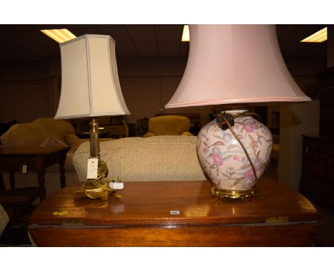 A modern Corinthian pattern table lamp with cream coloured shade and another ceramic vase shaped table lamp with pink shade.