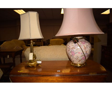 A modern Corinthian pattern table lamp with cream coloured shade and another ceramic vase shaped table lamp with pink shade.