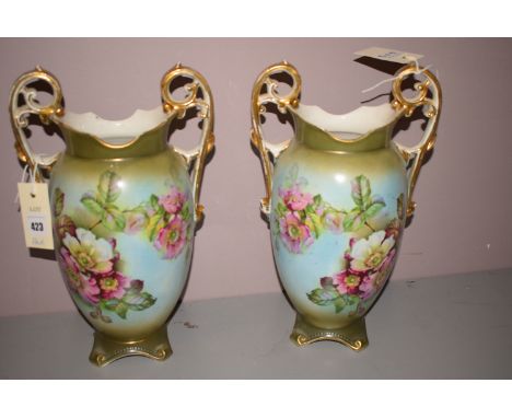 A pair of ceramic vases, by J. Kent, decorated flowers on blue and gilded ground.