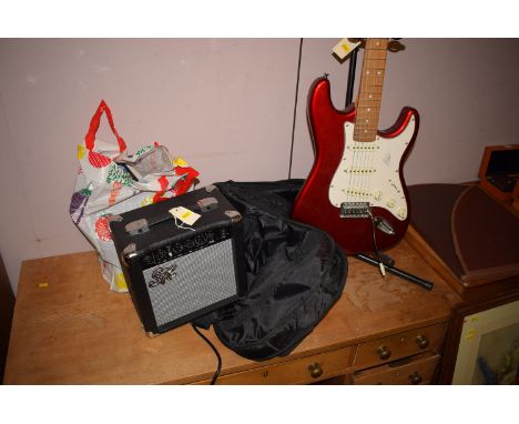 A modern electric guitar finished in metallic red with white finger board, the top inscribed "SX Standard Series Custom Hand-