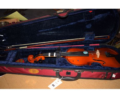 A student violin with paper label inscribed "The Stentor Student", in fitted case with a bow.