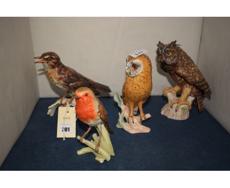 Four Goebel model birds, comprising: two owls; a robin; and a thrush.