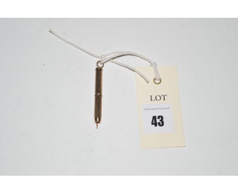 A 9ct. yellow gold extending toothpick, with engine turned decoration.