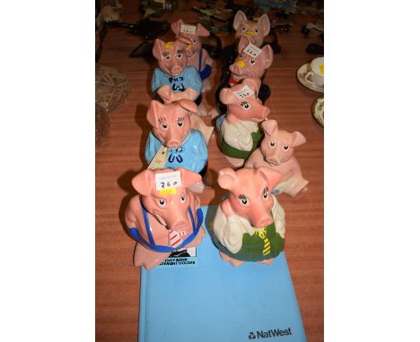 A collection of ten Wade ceramic pig money boxes, made for Natwest Bank; and a Natwest piggy bank statement holder.