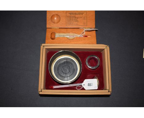 A French wine thermometer in wooden case; another wine thermometer; bottle stand; etc.