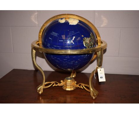 A large modern terrestrial mineral globe in brass gimbal.