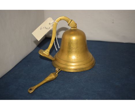 A small brass ship's style bell with wall mounting bracket.