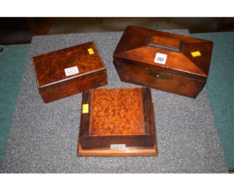 A Victorian two-compartment tea caddy; and two wooden cigarette boxes.