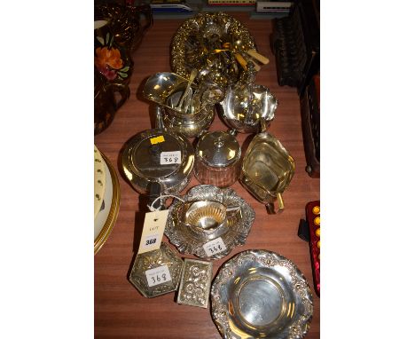A collection of miscellaneous plated metalware, comprising: cutlery; jugs; teapot; preserve jar and cover; an oval dish; etc.
