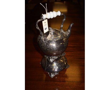 A large Britannia metal spirit kettle and stand, with engraved acanthus leaf decoration and white ceramic handle.