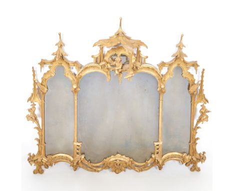 In the Chinese Chippendale style, the pagoda-form cresting with central full figure above divided cartouche-form mirror plate
