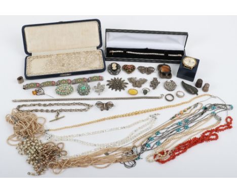 A selection of brooches, including a large tiger eye brooch, a yellow opal cabochon brooch, with a silver watch chain (53.5g)