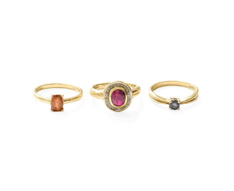 A 9 Carat Gold Garnet Ring, finger size N; A 9 Carat Gold Ruby and Diamond Cluster Ring, finger size N; and A 9 Carat Gold Al