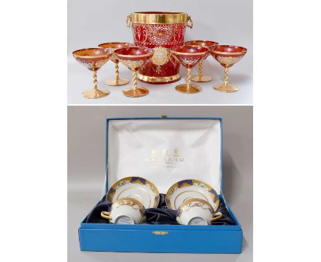 A Venetian Ruby Glass Champagne Bucket, a set of six matching champagne saucers, together with a pair of porcelain tea cups a