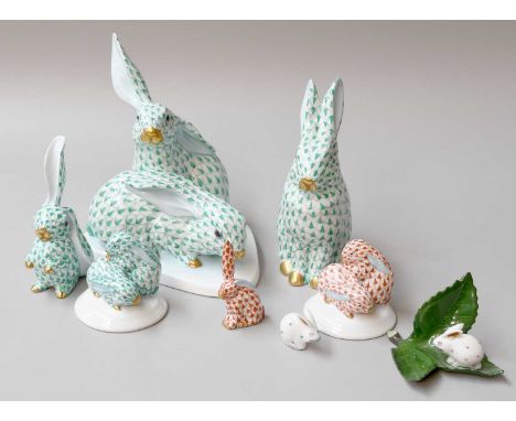 A Collection of Herend Porcelain Rabbit Models, in red and green, printed marks largest a pair on simple pad base, 15cm high 