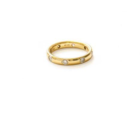 An 18 Carat Gold Diamond Eternity Ring, eight round brilliant cut diamonds inset within a yellow plain polished band, total e
