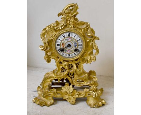 A French Gilt Metal Striking Mantel Clock, late 19th century, in rococo style case and with 3 inch porcelain dial, the twin b