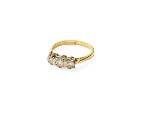 An 18 Carat Gold Diamond Three Stone Ring, the round brilliant cut diamonds in white claw settings, to a yellow tapered shoul