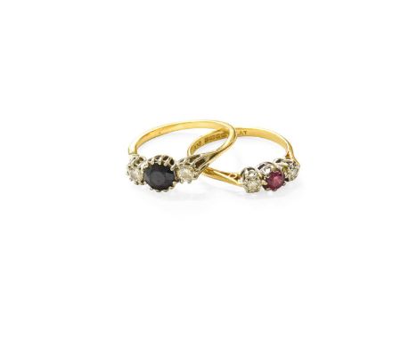 An 18 Carat Gold Ruby and Diamond Three Stone Ring, the round cut ruby flanked by eight-cut diamonds in white claw and illusi