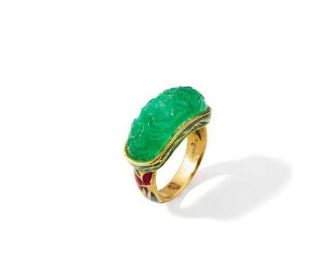 An Indian emerald and enamel ring The carved oval cabochon emerald, to a polychrome enamel 18ct gold mount and hoop, UK hallm