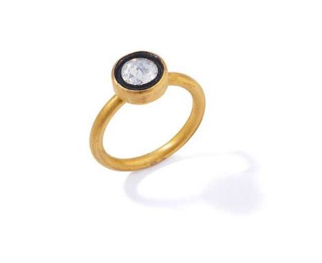 A diamond single-stone ring The rose-cut diamond collet-set within a black enamel surround, to a 24ct gold hoop, UK hallmarkD