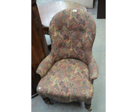 A Victorian walnut and upholstered button back nursing chair.