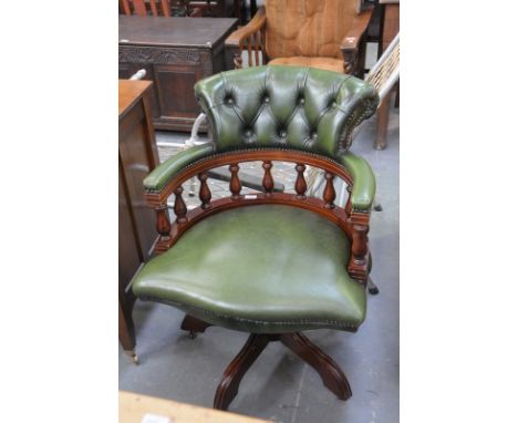 A Reproduction green leather button back revolving captains chair.