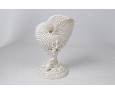 A Royal Worcester Nautilus shell vase, Circa 1880-90
The ivory glazed vase modelled as a large open shell, mounted on a coral