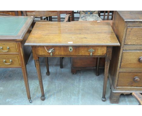 A 19th Century oak and walnut veneered side table
The rectangular plank top with a moulded border above a walnut veneered fri