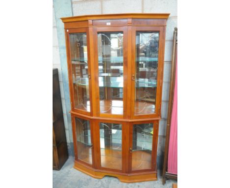 A Reproduction bow front yew wood wall display cabinet .