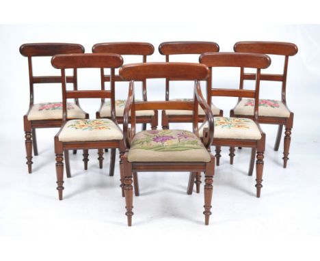 A set of seven William IV mahogany dining chairs
Comprising an elbow chair with a shaped cresting rail with a moulded border 