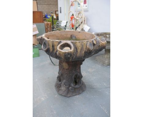 A Salt glazed stoneware trunk planter , the circular top with four off set planting apertures raised on a moulded bark effect