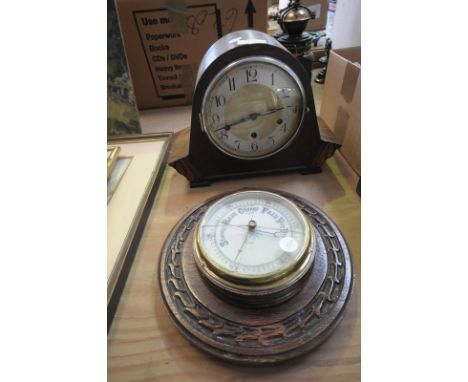 An Early 20th century oak cased mantel clock and a carved oak wheel barometer. (2)