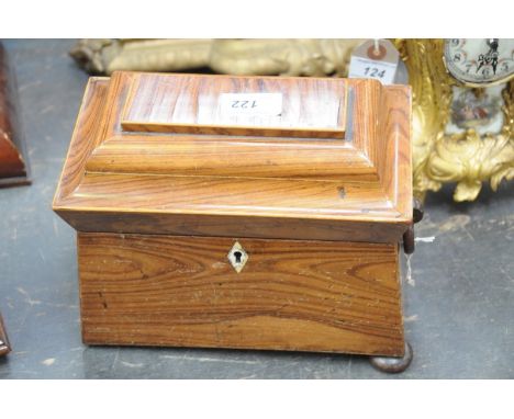 An early Victorian tea caddy
Of sarcophagus form the hinged lid with a rectangular panel enclosing a red velvet lined interio