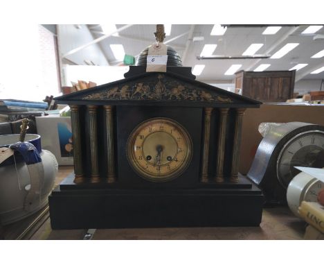 A Victorian architectural black slate mantel clock with a gilt metal dial and gilt metal fruit finial.