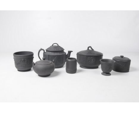 A collection of late 19th Century and later black basalt wares
Comprising a teapot and cover, the exterior sides relief mould