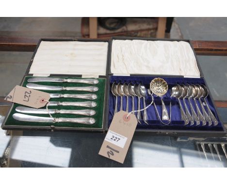 A Cased set of 12 silver plated teaspoons, sugar tongs and sifter and a cased set of 6 silver tea knives.