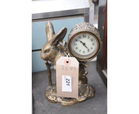 A Gilt metal hare figural timepiece,  the clock mounted in a barrel carried  on the back of a travelling hare.