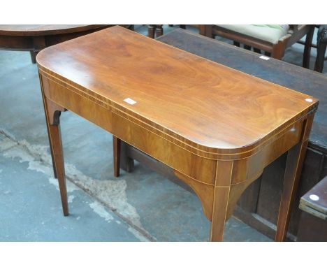 An Early 19th century mahogany folding tea table on legs of tapering square section. CONDITION REPORT: Replaced patch approx 